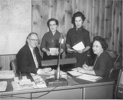 1952 - Herb DeRoth, Treasurer on left reviewing accounts receivable aging with accounting staff.