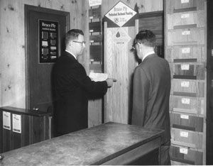 1963 - Robert A. Boyd, Jr. & Roy McLean, Sales Manager reviewing Bruce Flooring samples.