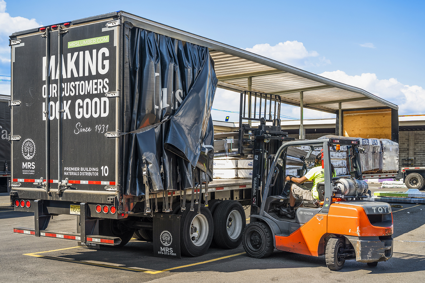 Forklift loading a truck with building materials at MRS open warehouse